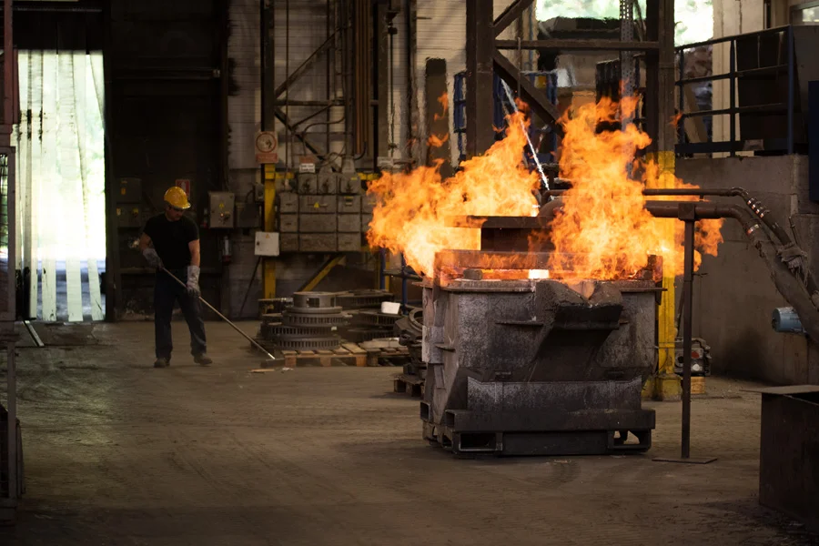 Pouring molten iron from induction furnace