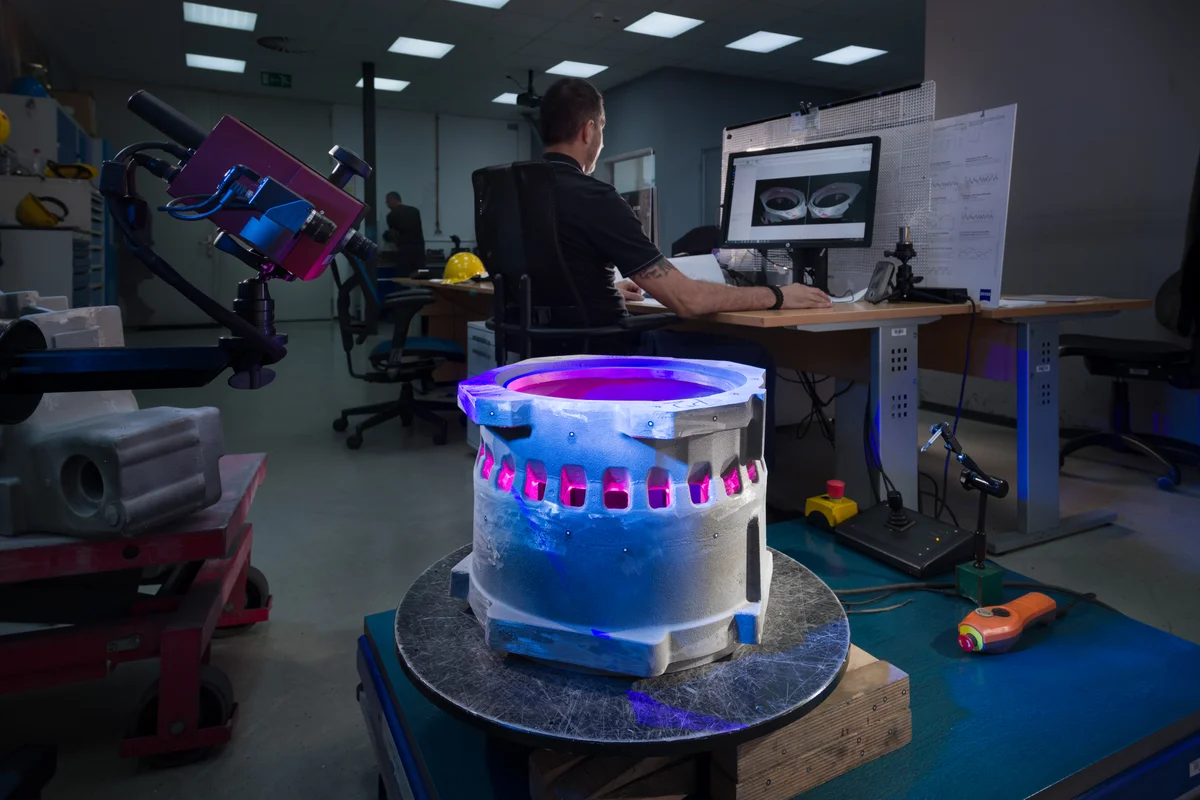 Engineer inspecting a casting under UV light